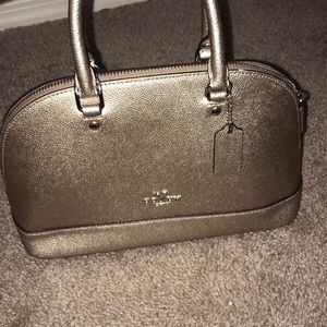 A small purple-ish color coach bag